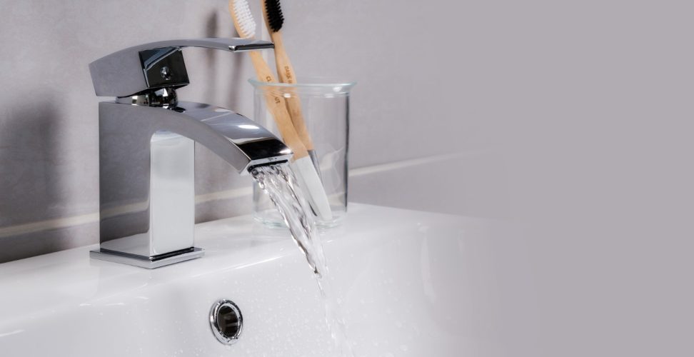 closeup-shot-water-flowing-from-basin-mixer-tap-bathroom