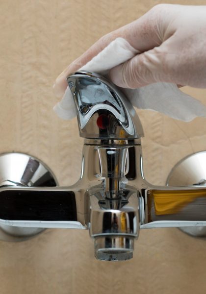 hand-with-glove-disinfecting-faucet